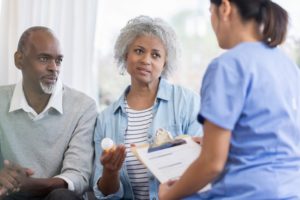 African American couple discusses medication concerns with a healthcare professional in her office