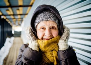 Portrait of 70 year old women dressed in warm winter clothing outdoors in winter