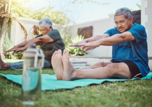 Fitness, yoga and senior couple stretching for exercise, zen and relax in a garden, peace and calm. Stretch, workout and elderly man with woman in a yard for training, pilates and cardio in Mexico